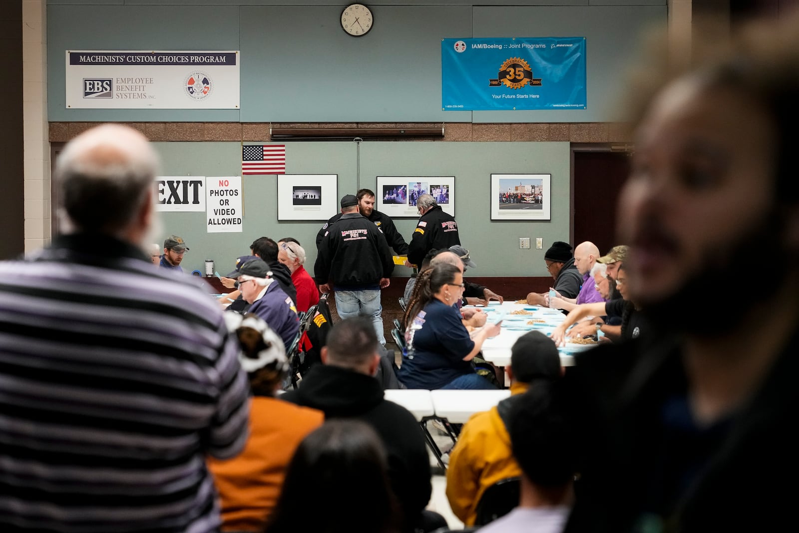 Observers watch as volunteers tally votes on a new contract offer from Boeing, Monday, Nov. 4, 2024, at the IAM District 751 Union Hall in Seattle. (AP Photo/Lindsey Wasson)