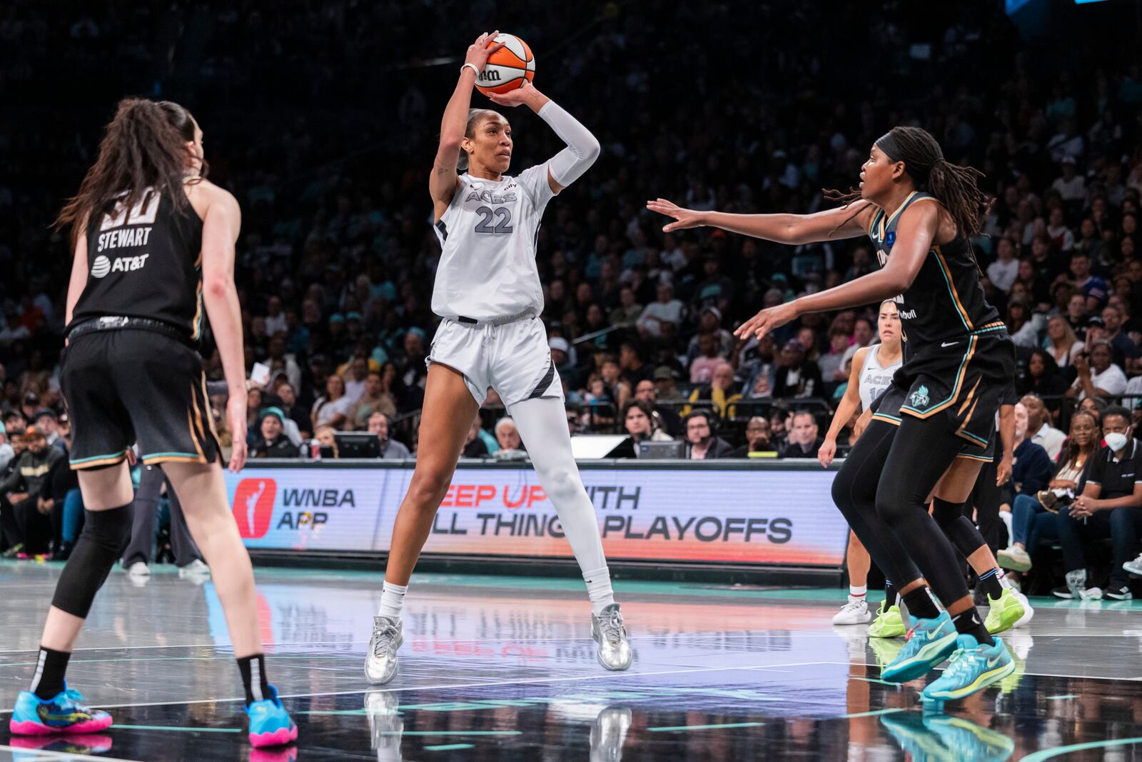 Las Vegas Aces center A'ja Wilson (22) looks to shoot between New York Liberty forwards Breanna Stewart (30) and Jonquel Jones, right, during the second half of a WNBA basketball second-round playoff game, Sunday, Sept. 29, 2024, in New York. (AP Photo/Corey Sipkin)