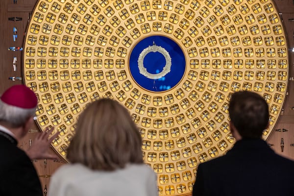 French President Emmanuel Macron, right, looks at the reliquary of the Crown of Thorns designed by French Artist Sylvain Dubuisson as he visits the restored interiors of the Notre-Dame de Paris cathedral, Friday, Nov. 29, 2024 in Paris. (Christophe Petit Tesson/Pool via AP)