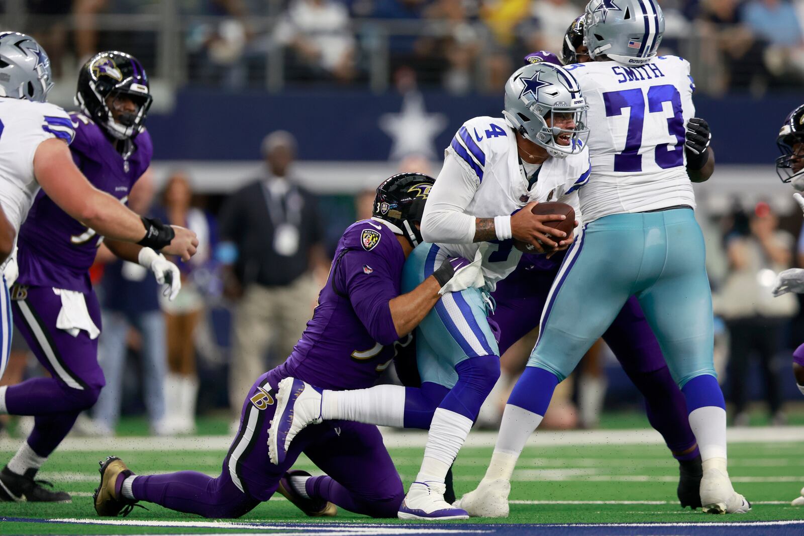 Baltimore Ravens linebacker Kyle Van Noy, left, sacks Dallas Cowboys quarterback Dak Prescott (4) in the first half of an NFL football game in Arlington, Texas, Sunday, Sept. 22, 2024. (AP Photo/Gareth Patterson)