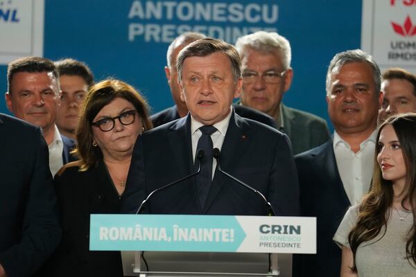 Presidential candidate Crin Antonescu, centre, attends a meeting with supporters after polls closed for the first round of the country's presidential election redo in Bucharest, Romania, Sunday, May 4, 2025. (AP Photo/Vadim Ghirda)