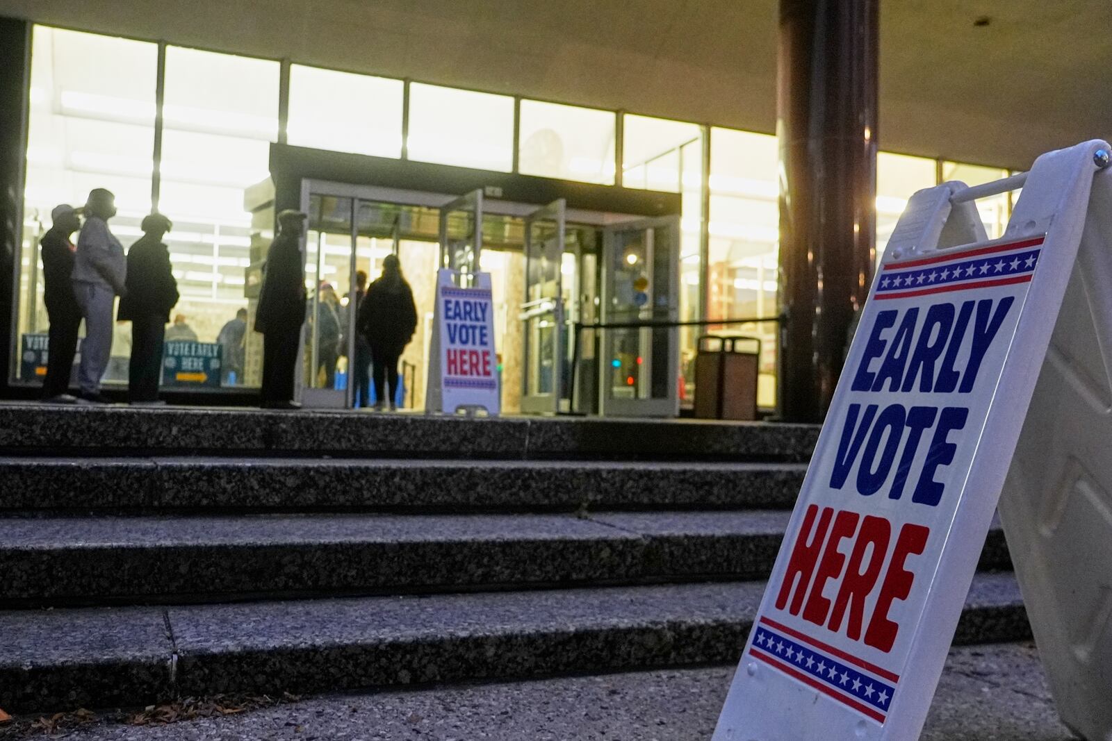 People line up outside the Frank P. Zeidler Municipal Building during the first day of Wisconsin's in-person absentee voting Tuesday, Oct. 22, 2024, in Milwaukee. (AP Photo/Morry Gash)