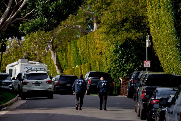 FILE - Law enforcement personnel walk on a street near after federal law enforcement executed a raid at a property belonging to Sean "Diddy" Combs on March 25, 2024, in Los Angeles. (AP Photo/Eric Thayer, File)