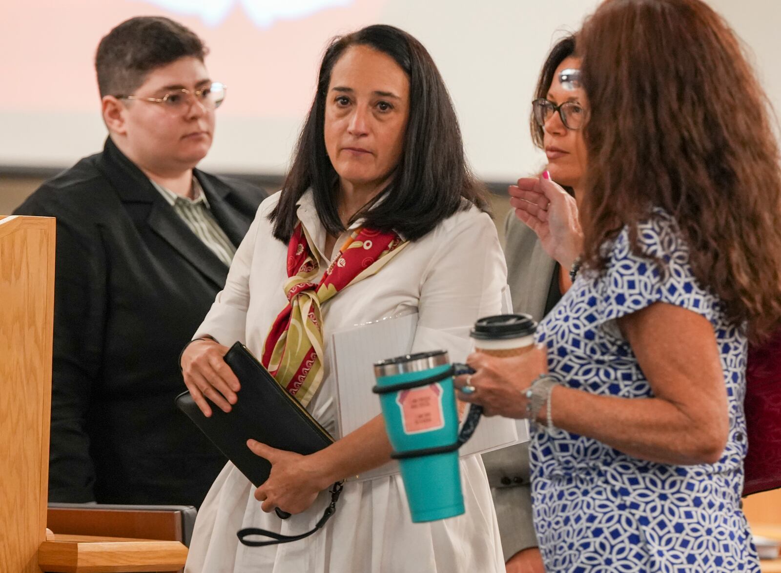 Renata Rojas, OceanGate mission specialist, center, pauses during at the Titan marine board formal hearing, inside the Charleston County Council Chambers, Thursday, Sept. 19, 2024, in North Charleston, S.C. (Corey Connor via AP, Pool)