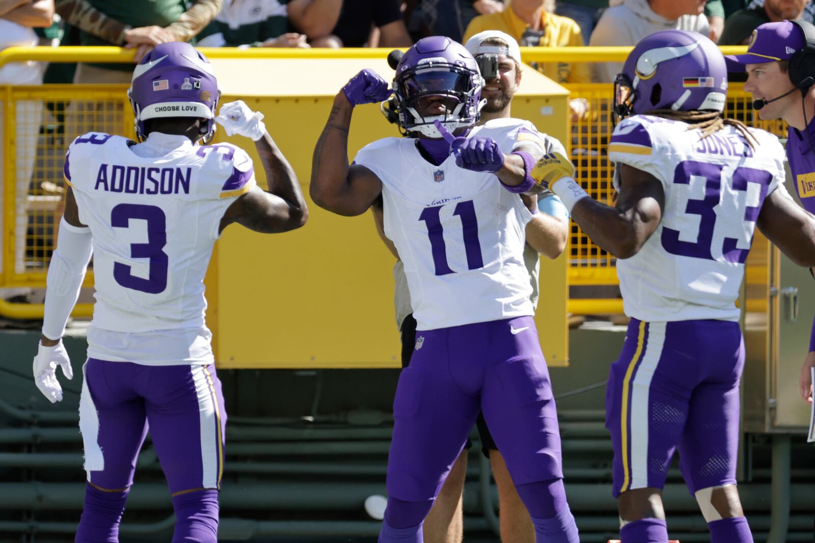 Minnesota Vikings wide receiver Jordan Addison (3) celebrates a touchdown with teammates Trent Sherfield Sr. (11) and Aaron Jones (33) during the first half of an NFL football game against the Green Bay Packers, Sunday, Sept. 29, 2024, in Green Bay, Wis. (AP Photo/Mike Roemer)