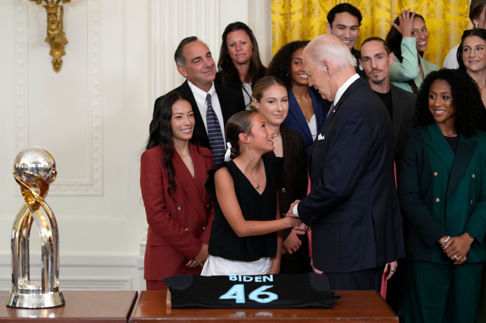 President Joe Biden greets a young girl during an event in the East Room of the White House in Washington, Monday, Sept. 23, 2024, to welcome the NJ/NY Gotham FC and celebrate their 2023 NWSL championship. (AP Photo/Susan Walsh)