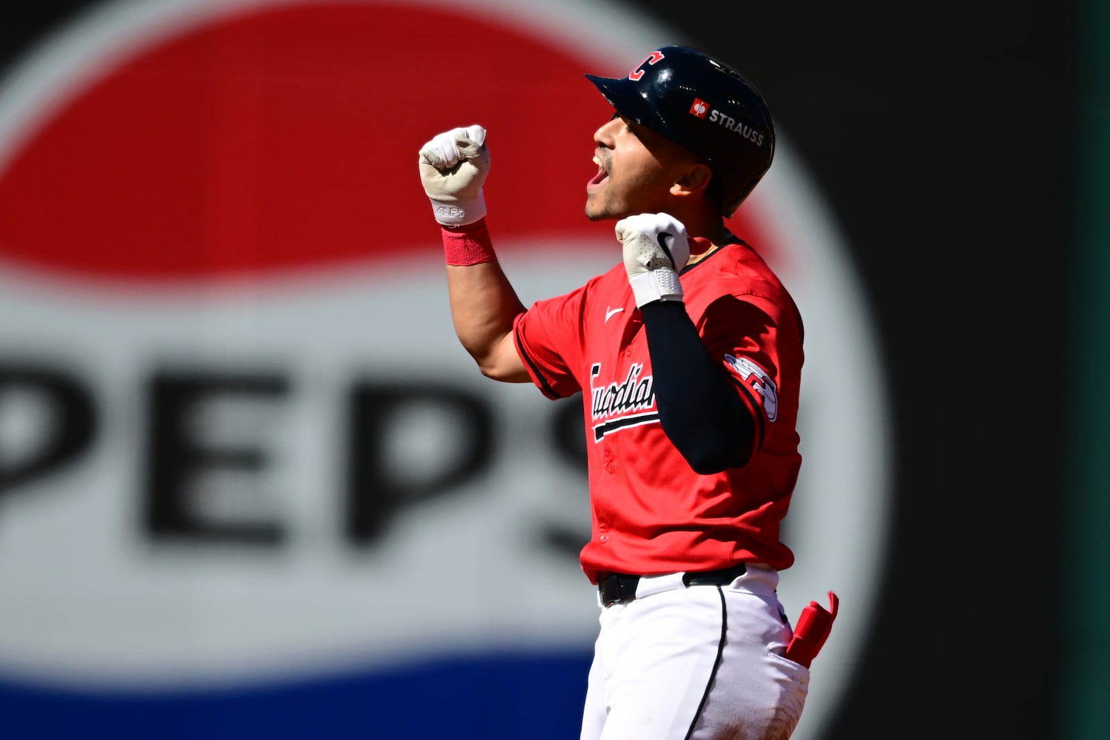 Cleveland Guardians left fielder Steven Kwan celebrates his double at second base in the first inning during Game 1 of the baseball's American League Division Series against the Detroit Tigers, Saturday, Oct. 5, 2024, in Cleveland. (AP Photo/David Dermer)