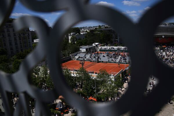 Visitors watch matchs before the draw of French Open tennis tournament Thursday, May 22, 2025 at the Roland Garros stadium in Paris. (AP Photo/Christophe Ena)