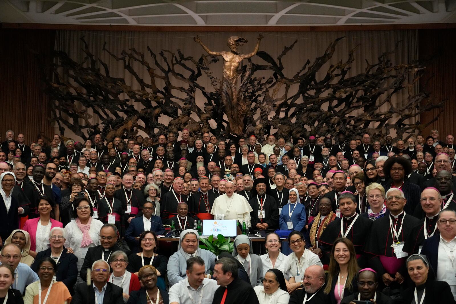 Pope Francis, background centre, poses with the participants to the second session of the 16th General Assembly of the Synod of Bishops gather in the Paul VI hall, at the Vatican, Saturday, Oct. 26, 2024. (AP Photo/Gregorio Borgia)