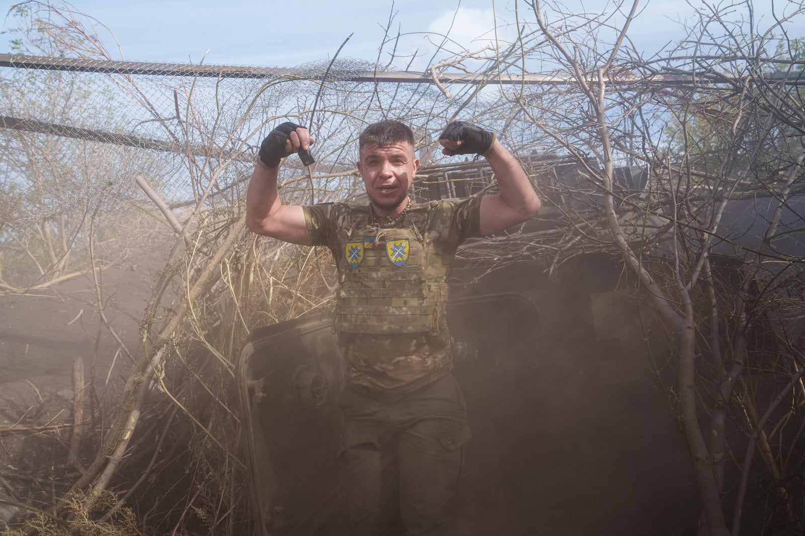 Ukrainian serviceman of 56th brigade reacts near self-propelled artillery vehicle after firing towards Russian positions at the frontline on Chasiv Yar direction, Donetsk region, Ukraine, Sept. 27, 2024. (AP Photo/Evgeniy Maloletka)