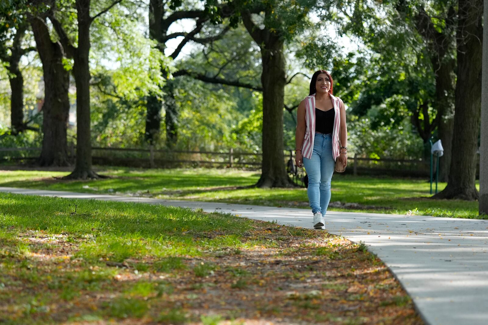 Julieth Luna Garcia, a transgender woman from El Salvador, takes a walk at Horner Park in Chicago, Monday, Sept. 30, 2024. (AP Photo/Nam Y. Huh)