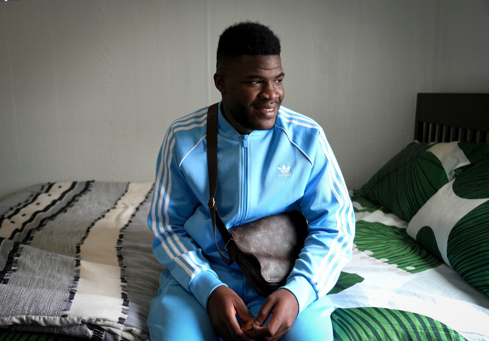 Cabrel Ngougou, a refugee from Cameroon, poses for a photo in San Francisco Tuesday, Sept. 17, 2024. (AP Photo/Terry Chea)