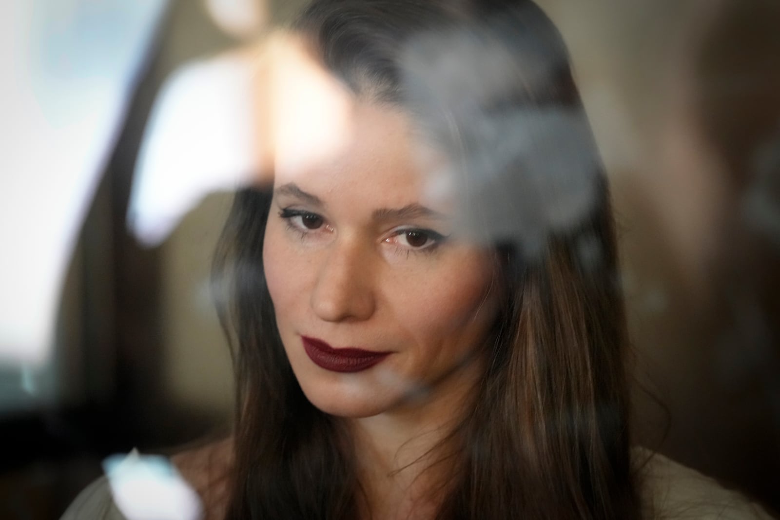 Russian journalist Antonina Favorskaya accused of working for a group founded by the late Russian opposition politician Alexei Navalny, stands in a defendant's cage of the Nagatinsky District Court in Moscow, Russia, on Wednesday, Oct. 2, 2024. (AP Photo)