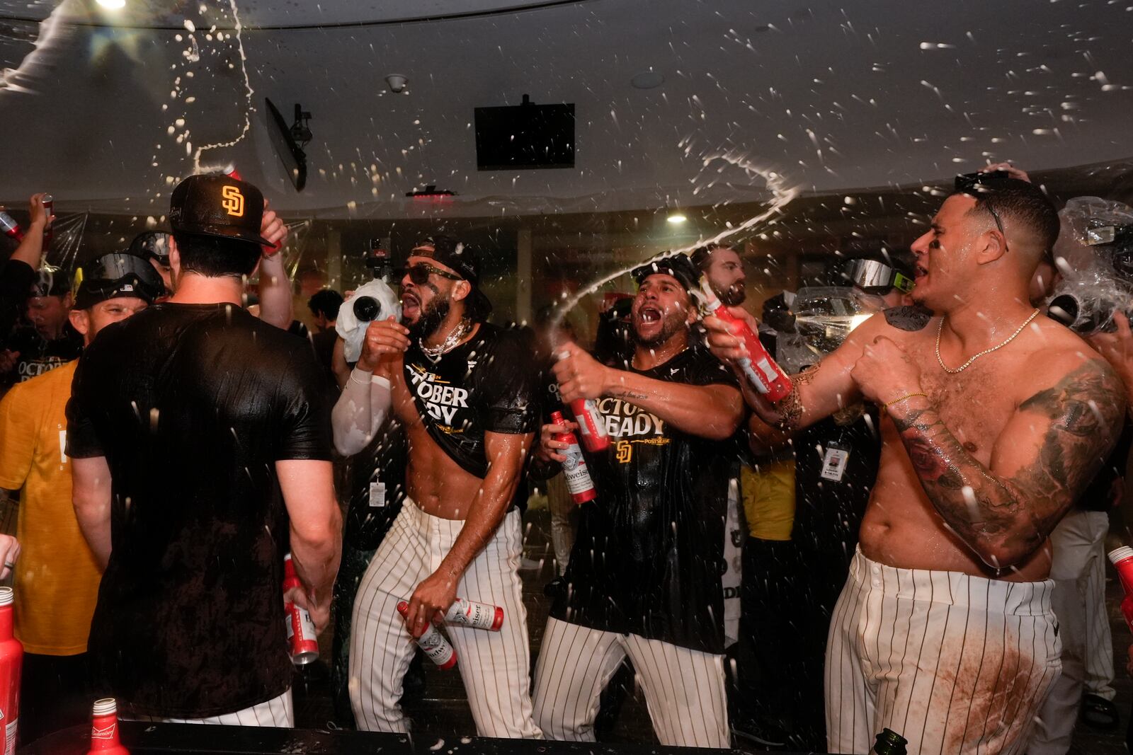 San Diego Padres players celebrate in the dugout after defeating the Atlanta Braves in Game 2 of an NL Wild Card Series baseball game Wednesday, Oct. 2, 2024, in San Diego. (AP Photo/Gregory Bull)