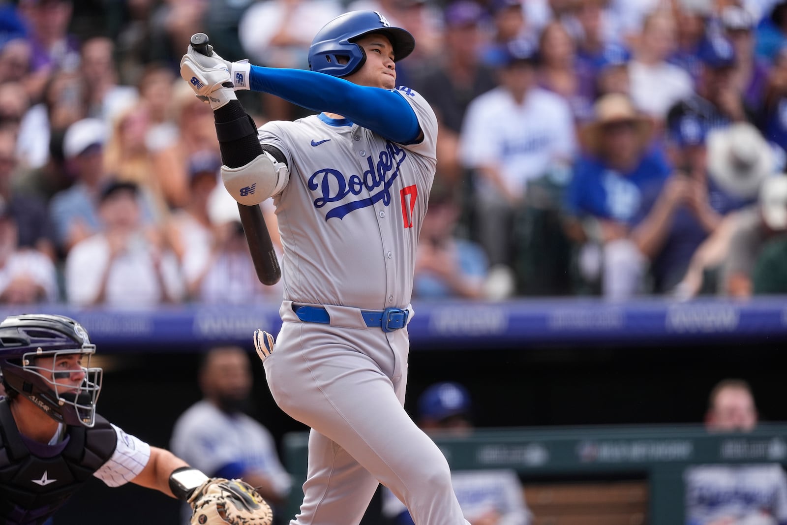 Los Angeles Dodgers' Shohei Ohtani follows the flight of his single off Colorado Rockies pitcher Seth Halvorsen in the eighth inning of a baseball game Sunday, Sept. 29, 2024, in Denver. (AP Photo/David Zalubowski)