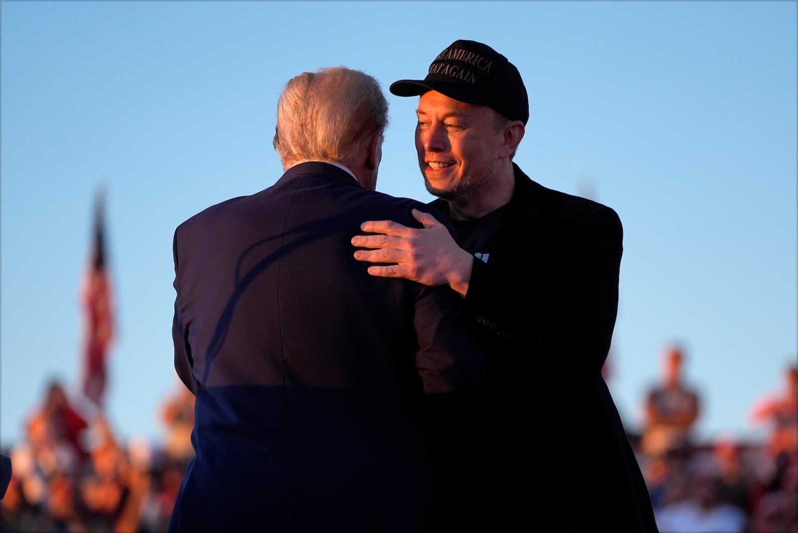 Republican presidential nominee former President Donald Trump hugs Elon Musk at a campaign rally at the Butler Farm Show, Saturday, Oct. 5, 2024, in Butler, Pa. (AP Photo/Evan Vucci)