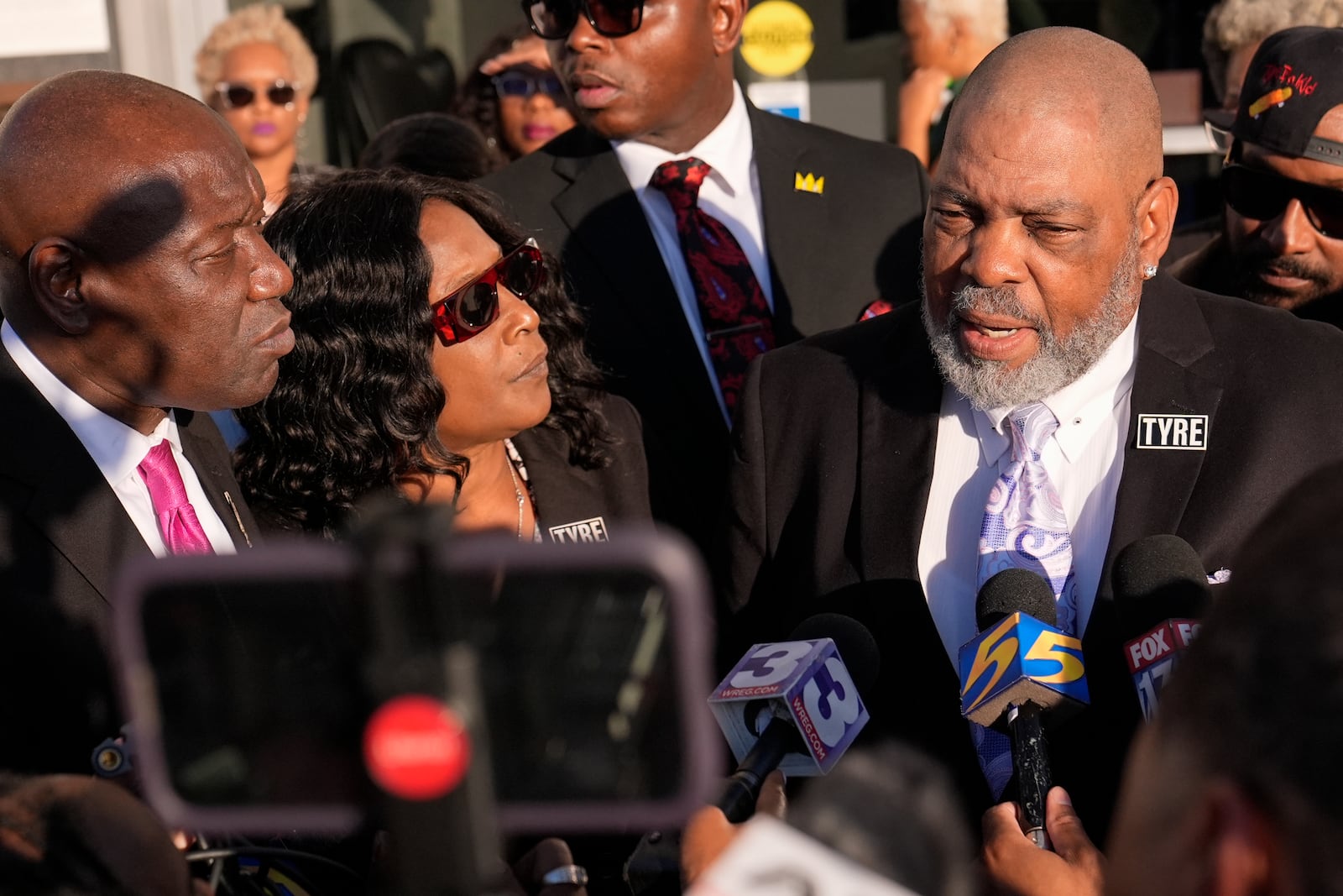 Rodney Wells, right, stepfather of Tyre Nichols, speaks during a news conference with his wife RowVaughn Wells, center, and attorney Ben Crump, left, outside the federal courthouse after three former Memphis police officers were convicted of witness tampering charges in the 2023 fatal beating of their son Nichols, Thursday, Oct. 3, 2024, in Memphis, Tenn. (AP Photo/George Walker IV)