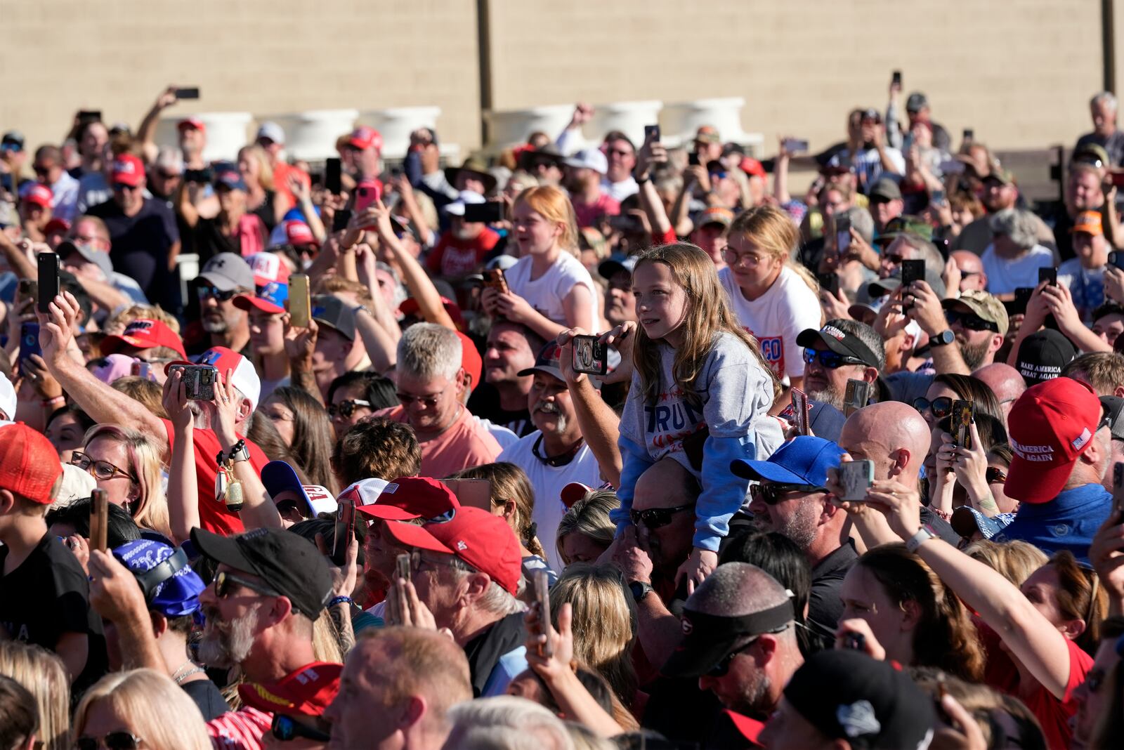 People listen as Republican presidential nominee former President Donald Trump speaks to an overflow crowd after a faith town halla at Christ Chapel Zebulon, Wednesday, Oct. 23, 2024, in Zebulon, Ga. (AP Photo/Alex Brandon)