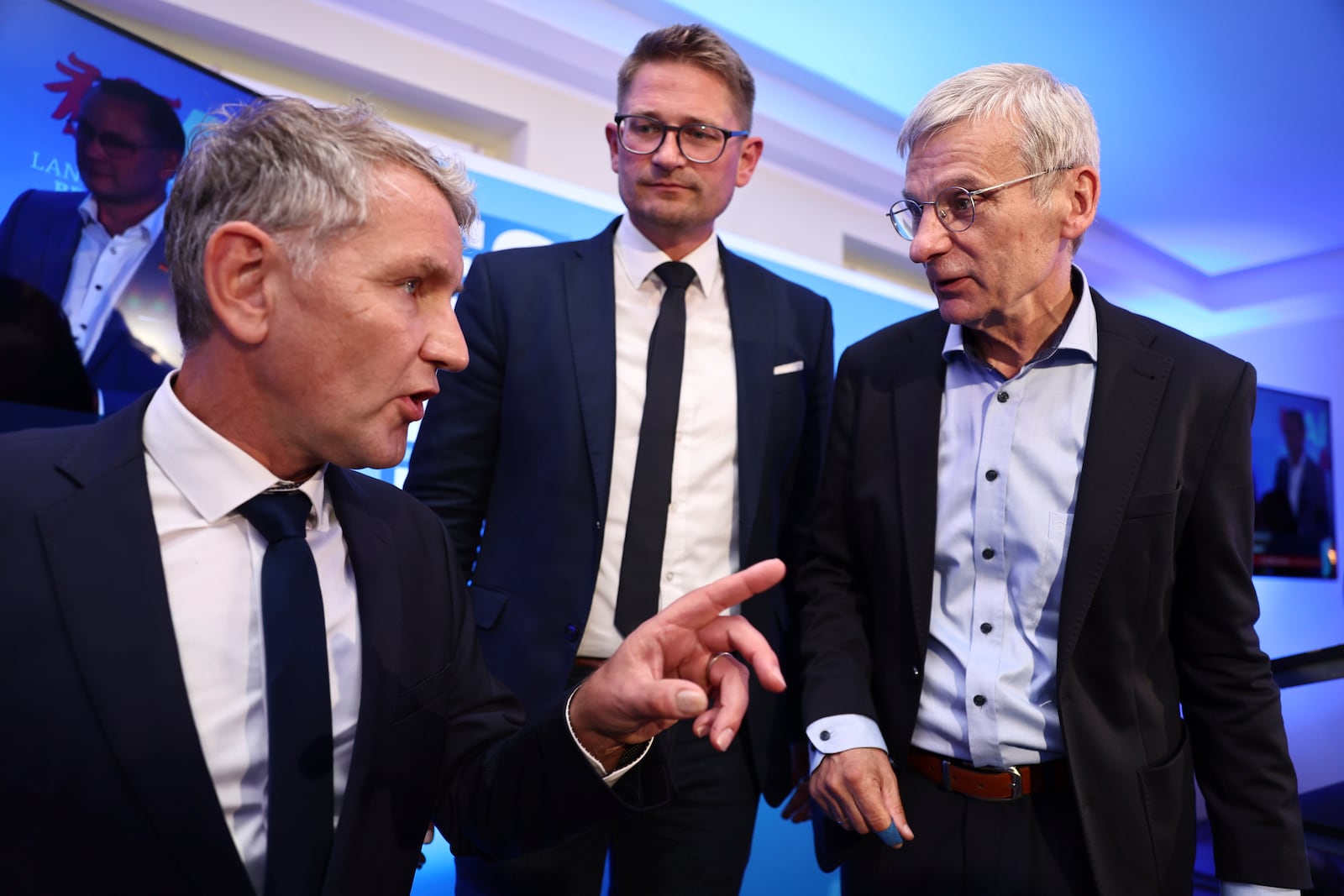 AfD state chairman, Bjoern Hoecke, left, spokesman for the AfD Thuringia state association, and Hans-Christoph Berndt, deputy chairman of the AfD Brandenburg and top candidate, talk at the AfD election party for the state election in the German state of Brandenburg in Potsdam, Germany, Sunday Sept. 22, 2024. (Christoph Soeder/dpa via AP)