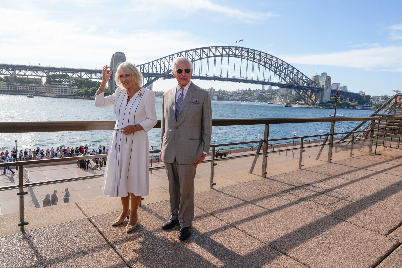 Britain's King Charles III, right, and Queen Camilla stand in front of the Sydney Harbour Bridge during their visit in Sydney, Australia, Tuesday, Oct. 22, 2024. (AP Photo/Mark Baker, Pool)