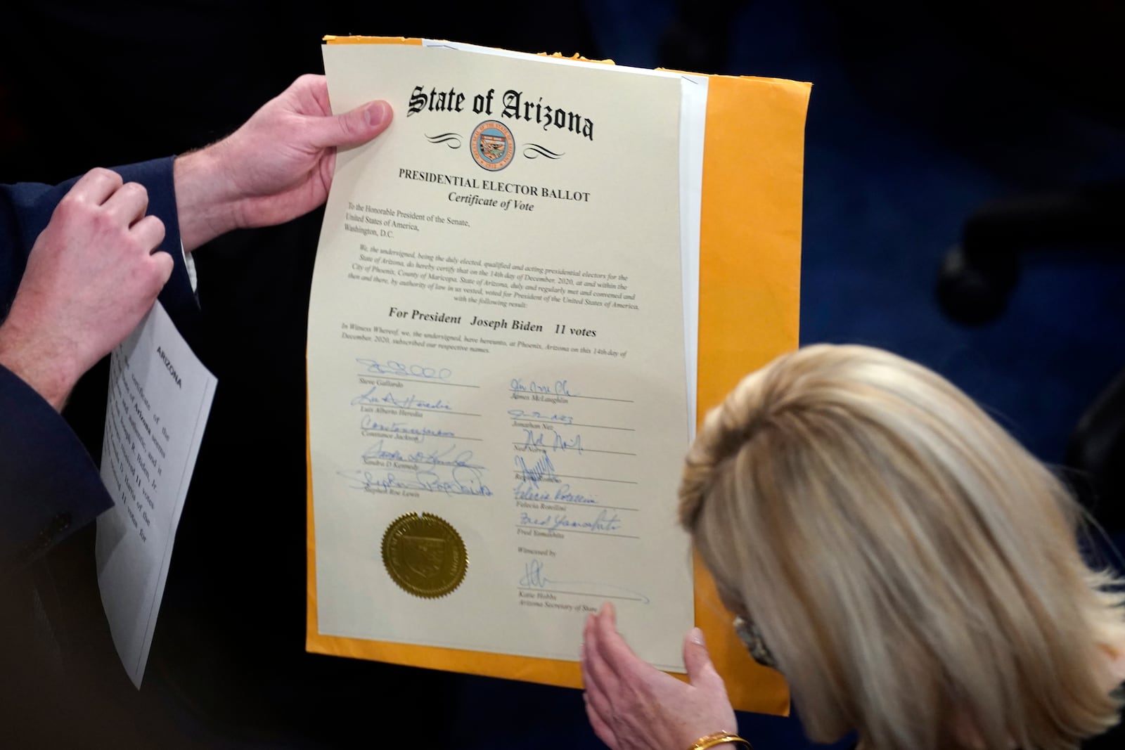 FILE - The certification of Electoral College votes for the state of Arizona is unsealed during a joint session of the House and Senate convenes to confirm the electoral votes cast in November's election, at the Capitol, Jan 6, 2021. (AP Photo/Andrew Harnik, File)