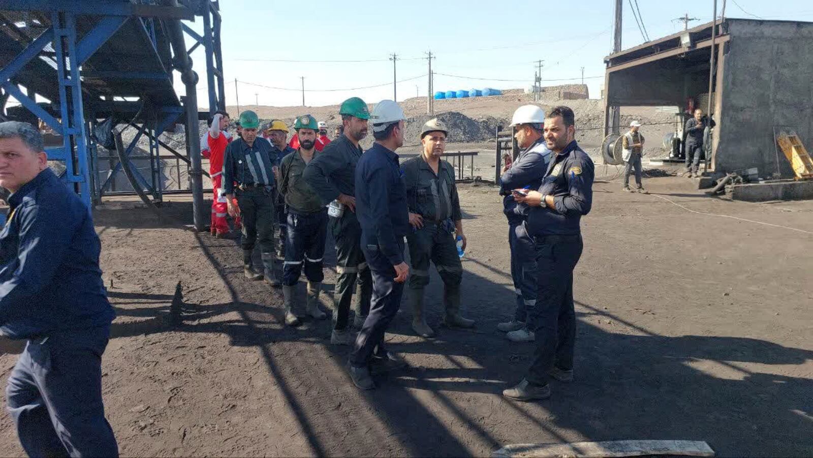 In this photo released on Tuesday, Sept. 24, 2024, by Iranian Interior Ministry, miners stand at the site of a coal mine where methane leak sparked an explosion on Saturday, in Tabas, some 335 miles (540 kilometers) southeast of the capital Tehran, Iran. (Iranian Interior Ministry via AP)