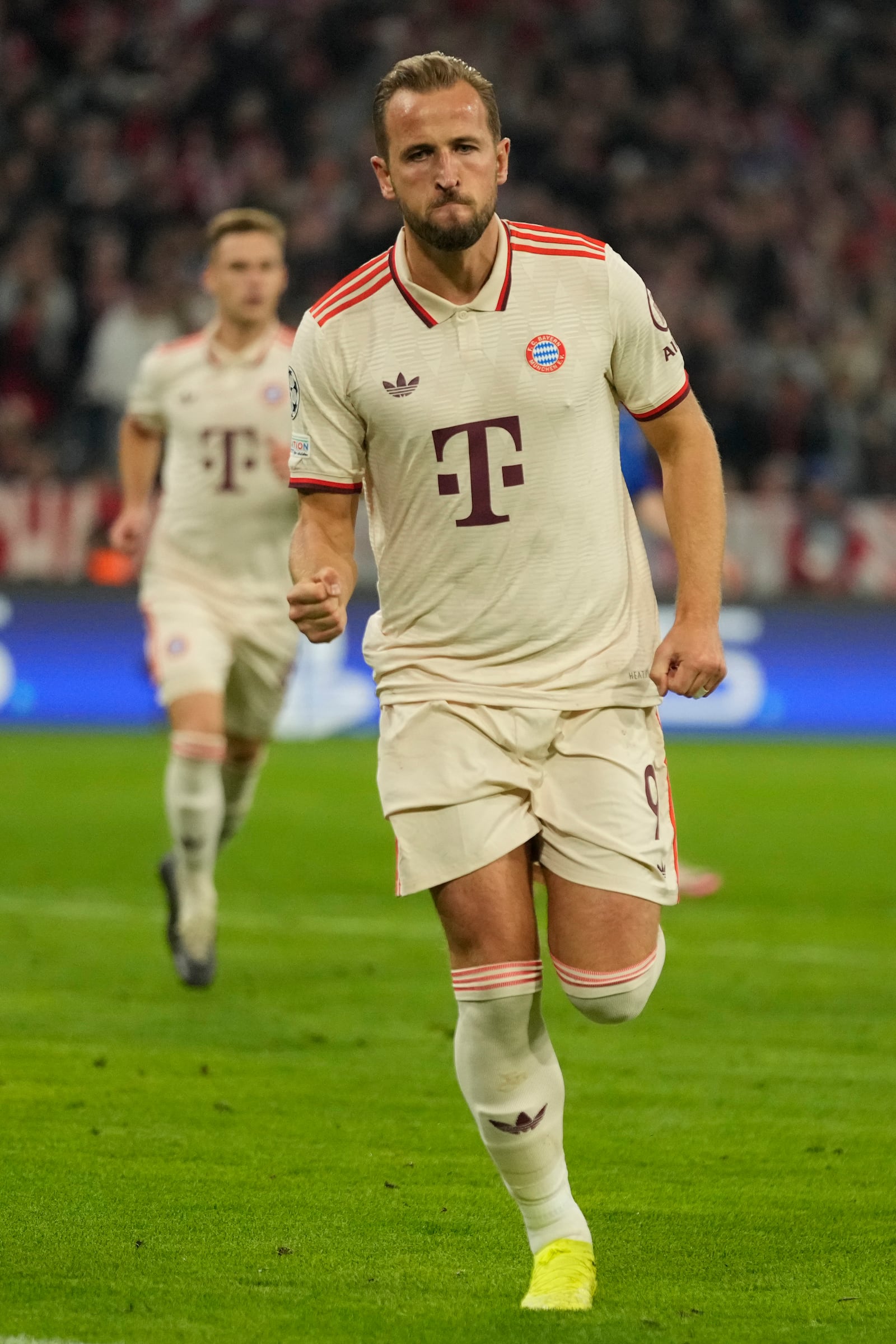 Bayern's Harry Kane celebrates after scoring the opening goal from the penalty sport during the Champions League opening phase soccer match between Bayern Munich and GNK Dinamo at the Allianz Arena in Munich, Germany Tuesday, Sept. 17, 2024. (AP Photo/Matthias Schrader)