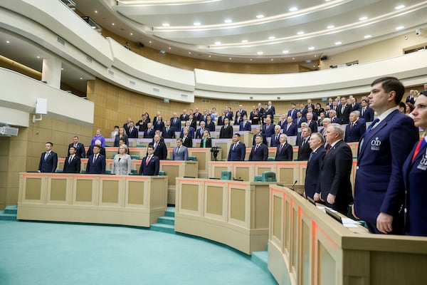 In this photo released by the Federation Council of The Federal Assembly of the Russian Federation Press Service, lawmakers of Federation Council of the Federal Assembly of the Russian Federation listen to the national anthem prior to a session in Moscow, Wednesday, Nov. 20, 2024. (The Federation Council of The Federal Assembly of The Russian Federation Press Service via AP)