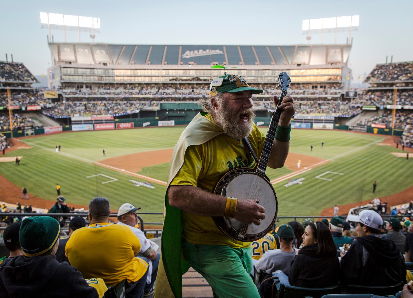 FILE - Oakland Athletics fan "Banjo Man" (aka Stacy Samuels) plays for the crowd in the fifth inning of Game 5 of an American League baseball division series between the Oakland Athletics and the Detroit Tigers in Oakland, Calif., Thursday, Oct. 10, 2013. (AP Photo/Aaron Kehoe, File)