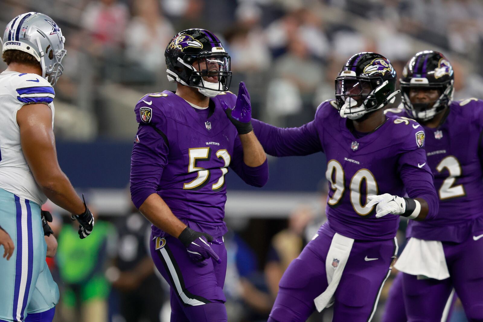 Baltimore Ravens linebacker Kyle Van Noy (53) celebrates with David Ojabo (90) after sacking Dallas Cowboys quarterback Dak Prescott in the first half of an NFL football game in Arlington, Texas, Sunday, Sept. 22, 2024. (AP Photo/Gareth Patterson)