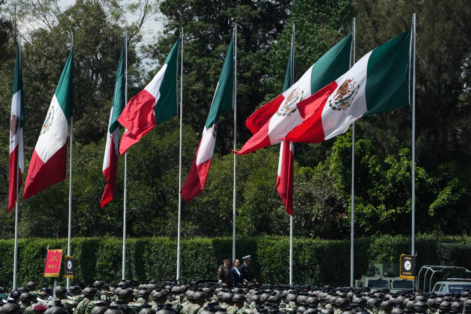 Mexican President Claudia Sheinbaum, center, reviews the troops with Defense Minister Gen. Ricardo Trevilla Trejo, left, and Navy Secretary Alt. Raymundo Pedro Morales at Campo Marte in Mexico City, Thursday, Oct. 3, 2024. (AP Photo/Fernando Llano)