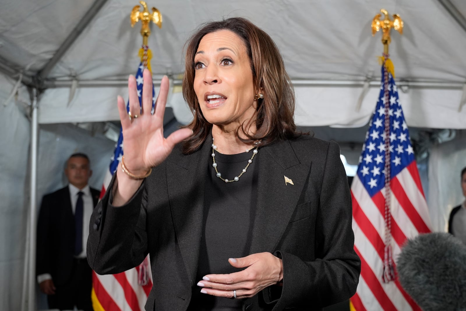 Democratic presidential nominee Vice President Kamala Harris speaks with reporters before a campaign event at Riverside Park in Grand Rapids, Mich., Friday, Oct. 18, 2024. (AP Photo/Jacquelyn Martin)