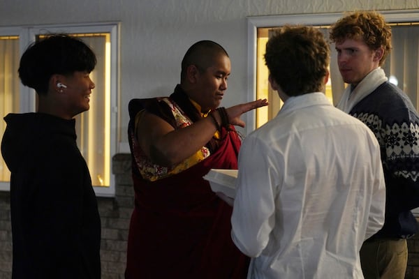 U.S.-born Buddhist lama, Jalue Dorje, talks with his high school friends near the end of his 18th birthday and enthronement ceremony, in Isanti, Minn., on Saturday, Nov. 9, 2024. (AP Photo/Jessie Wardarski)