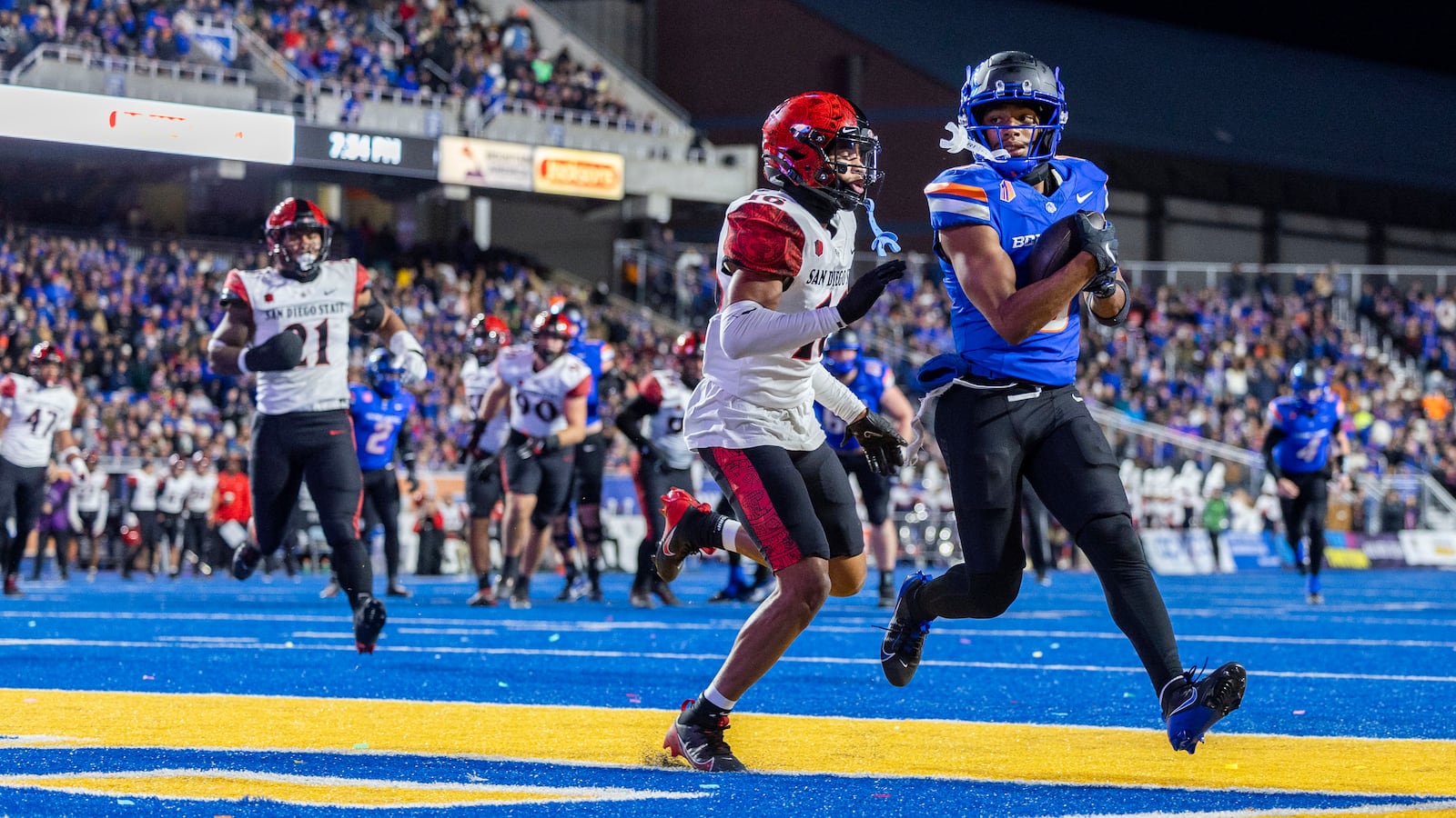 Boise State wide receiver Latrell Caples scores while being defended by San Diego State cornerback Jelani Whitmore during the first half of an NCAA college football game, Friday, Nov. 1, 2024 in Boise, Idaho. (Darin Oswald/Idaho Statesman via AP)