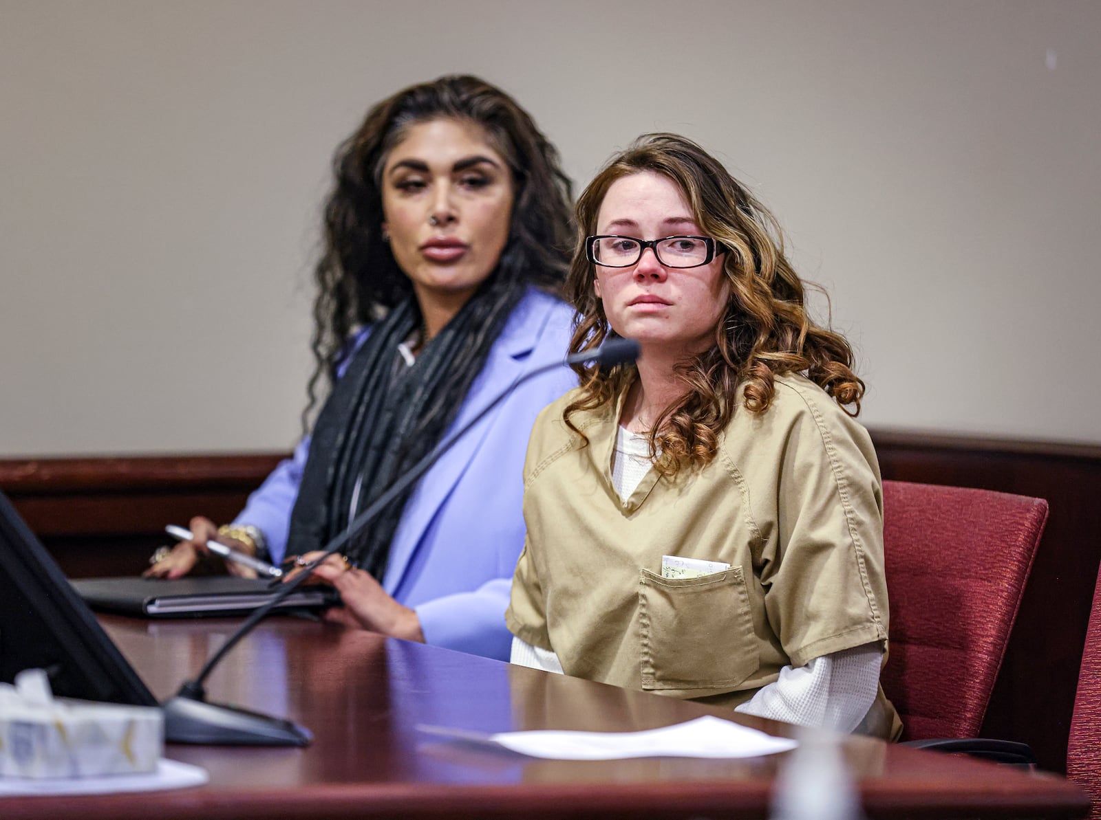 Hannah Gutierrez-Reed, the weapons supervisor on the set of the Western film “Rust," right, sits beside paralegal Carmella Sisneros at the start of her plea hearing at the First Judicial District Courthouse in Santa Fe, N.M., Monday, Oct. 7, 2024. (Gabriela Campos/Santa Fe New Mexican via AP, Pool)