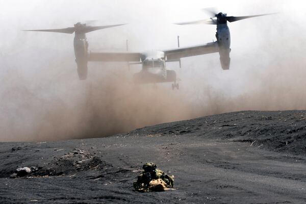 FILE - An MV-22 Osprey takes off as Japan Ground Self-Defense Force guards the landing zone during a joint military drill with U.S. Marines in Gotemba, southwest of Tokyo, March 15, 2022. (AP Photo/Eugene Hoshiko, File)