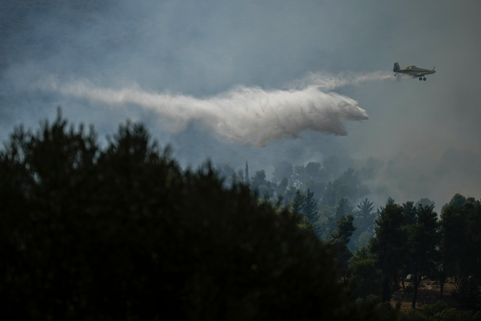 An Israeli firefighters plane uses a fire retardant to extinguish a fire after a rocket fired from Lebanon hit an open area near the city of Safed, northern Israel, on Wednesday, Sept. 25, 2024. (AP Photo/Leo Correa)