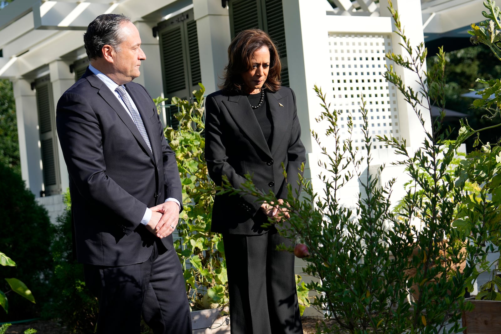 Democratic presidential nominee Vice President Kamala Harris, right, and second gentleman Doug Emhoff stand after planting a memorial tree on the grounds of the Vice President's residence in Washington on Monday, Oct. 7, 2024, to honor the victims and mark one year since the Oct. 7, 2023, Hamas attack on Israel. (AP Photo/Ben Curtis)