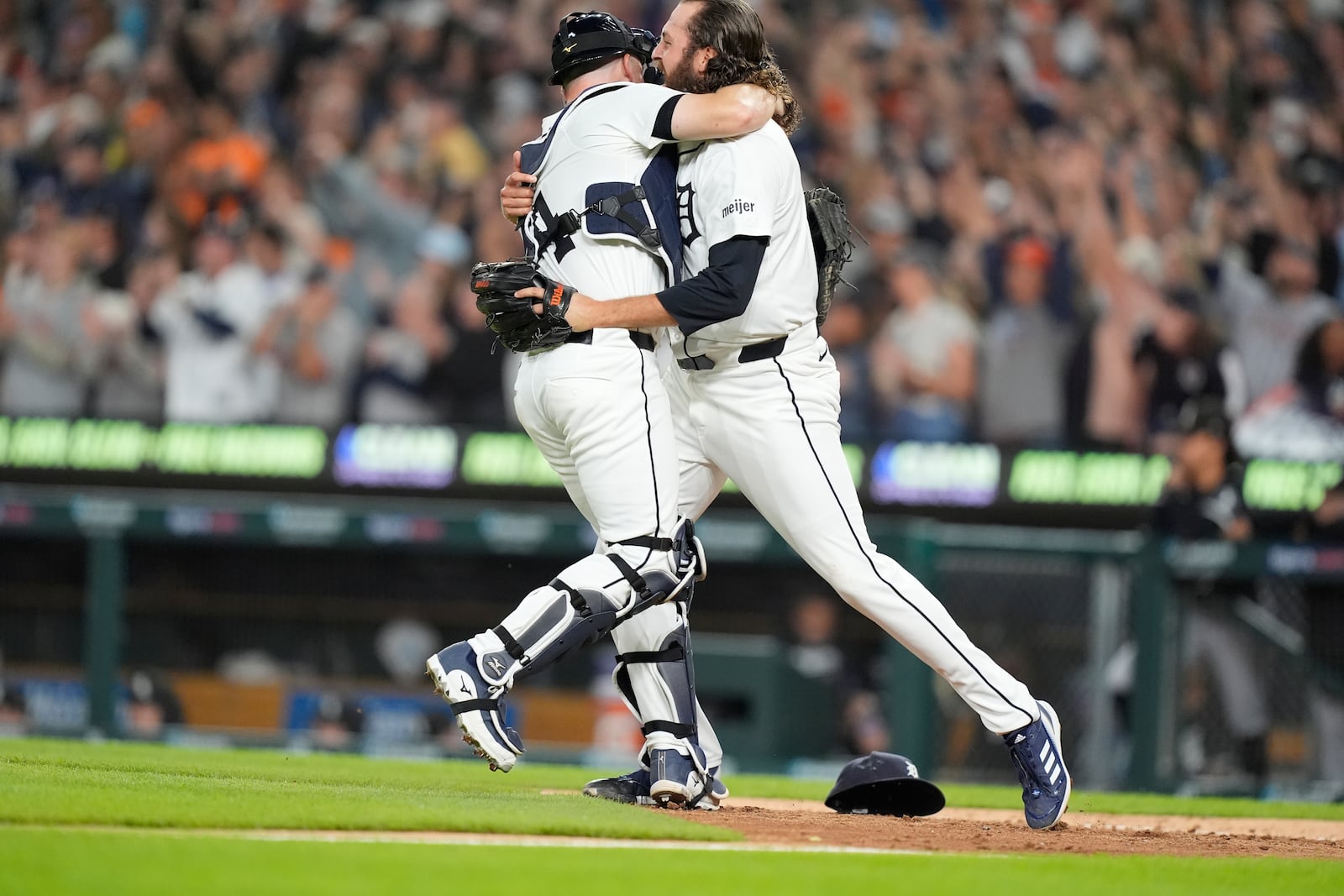 Detroit Tigers catcher Jake Rogers, left, and relief pitcher Jason Foley celebrate after the ninth inning of a baseball game against the Chicago White Sox, Friday, Sept. 27, 2024, in Detroit. (AP Photo/Carlos Osorio)