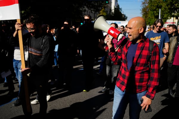 Protesters take part in rally, during a nationwide general strike organized by private and public sector unions demanding for better wages, in Athens, Greece, Wednesday, Nov. 20, 2024. (AP Photo/Thanassis Stavrakis)