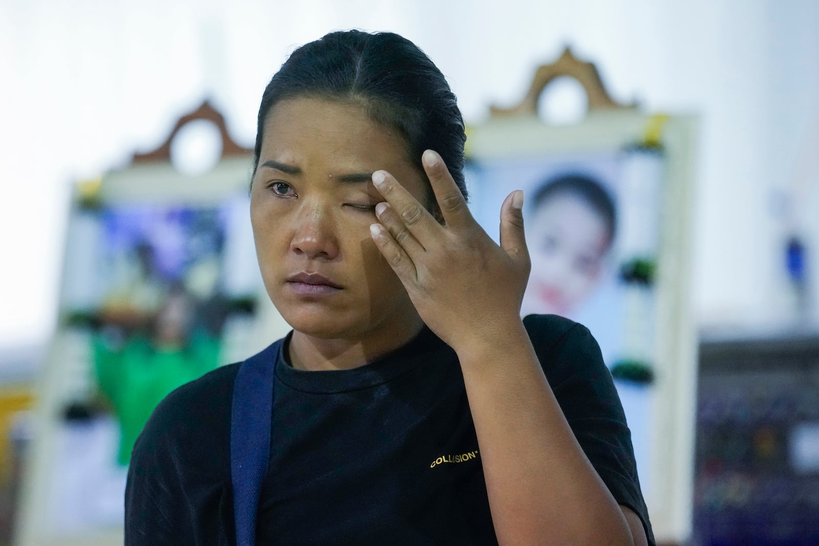 A relative of a victim of school bus fire cries at Wat Khao Phraya Sangkharam School Lan Sak, Uthai Thani province, Thailand, Thursday, Oct. 3, 2024. (AP Photo/Sakchai Lalit)