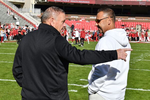 Arkansas coach Sam Pittman, left, and Texas coach Steve Sarkisian talk before the start of an NCAA college football game Saturday, Nov. 16, 2024, in Fayetteville, Ark. (AP Photo/Michael Woods)