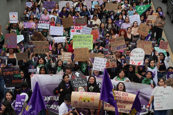 People take part in a march marking the upcoming International Day for the Elimination of Violence Against Women, in Lima, Peru, Saturday, Nov. 23, 2024. (AP Photo/Guadalupe Pardo)