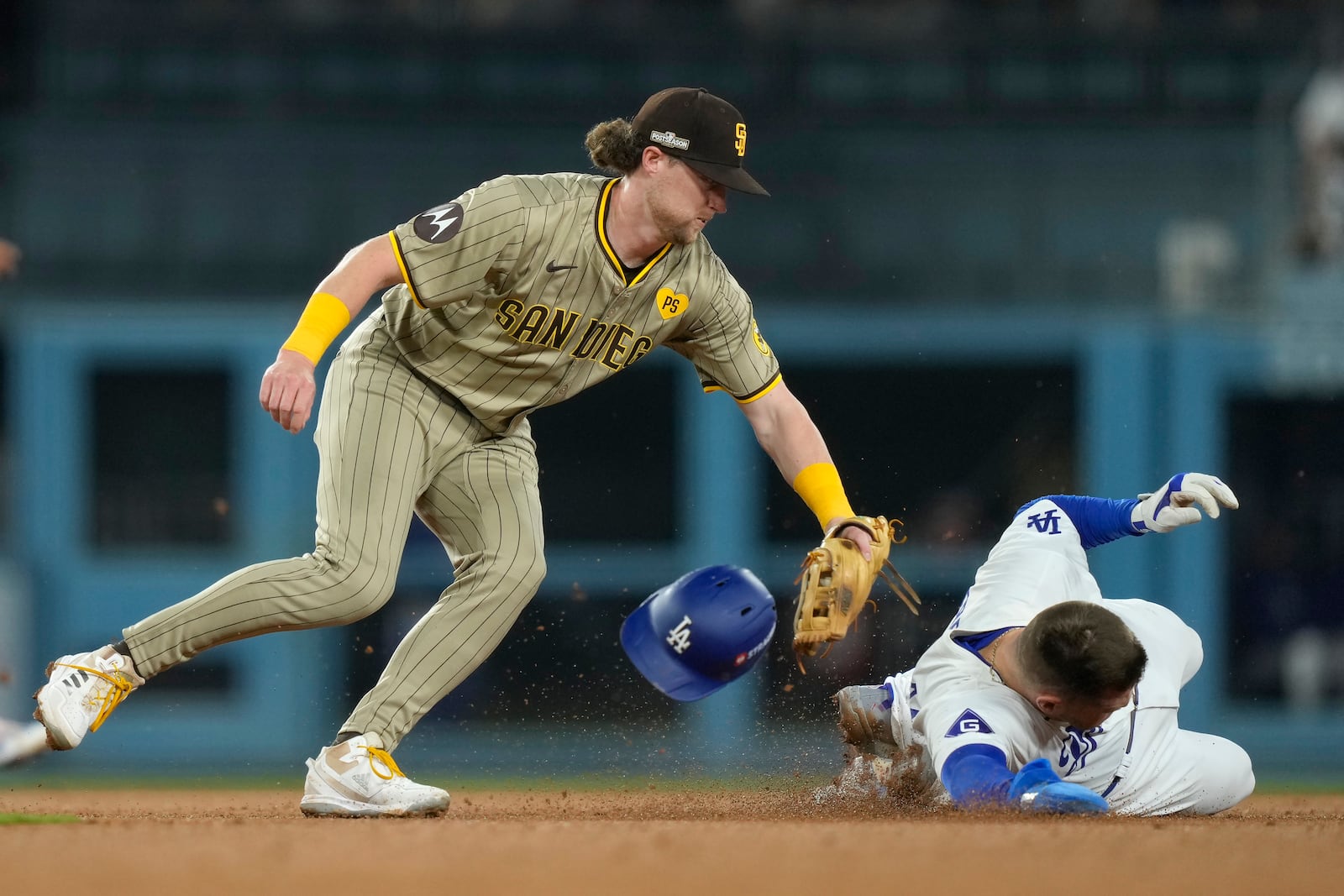 Los Angeles Dodgers' Freddie Freeman, right, steals second base against San Diego Padres second baseman Jake Cronenworth, left, during the third inning in Game 1 of baseball's NL Division Series Saturday, Oct. 5, 2024, in Los Angeles. (AP Photo/Mark J. Terrill)