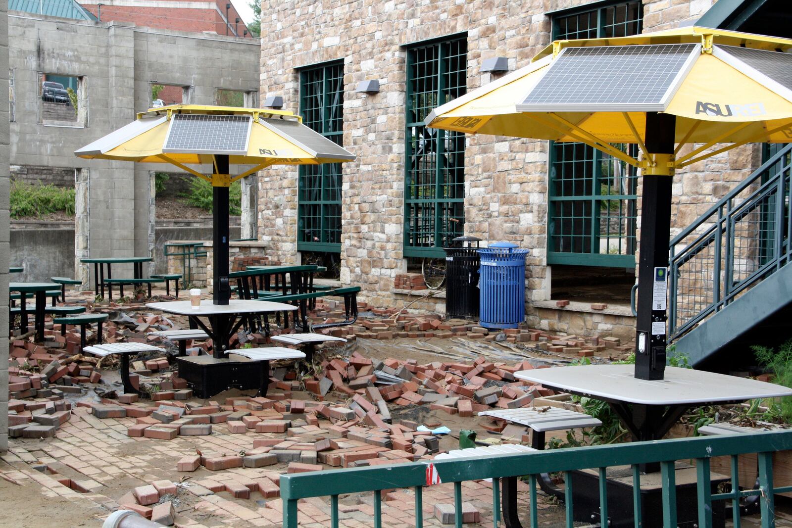 Bricks lie scattered from the destruction and flooding of Tropical Storm Helene at an outdoor seating area in downtown Boone, N.C., on Monday, Sept. 30, 2024. (AP Photo/Makiya Seminera)