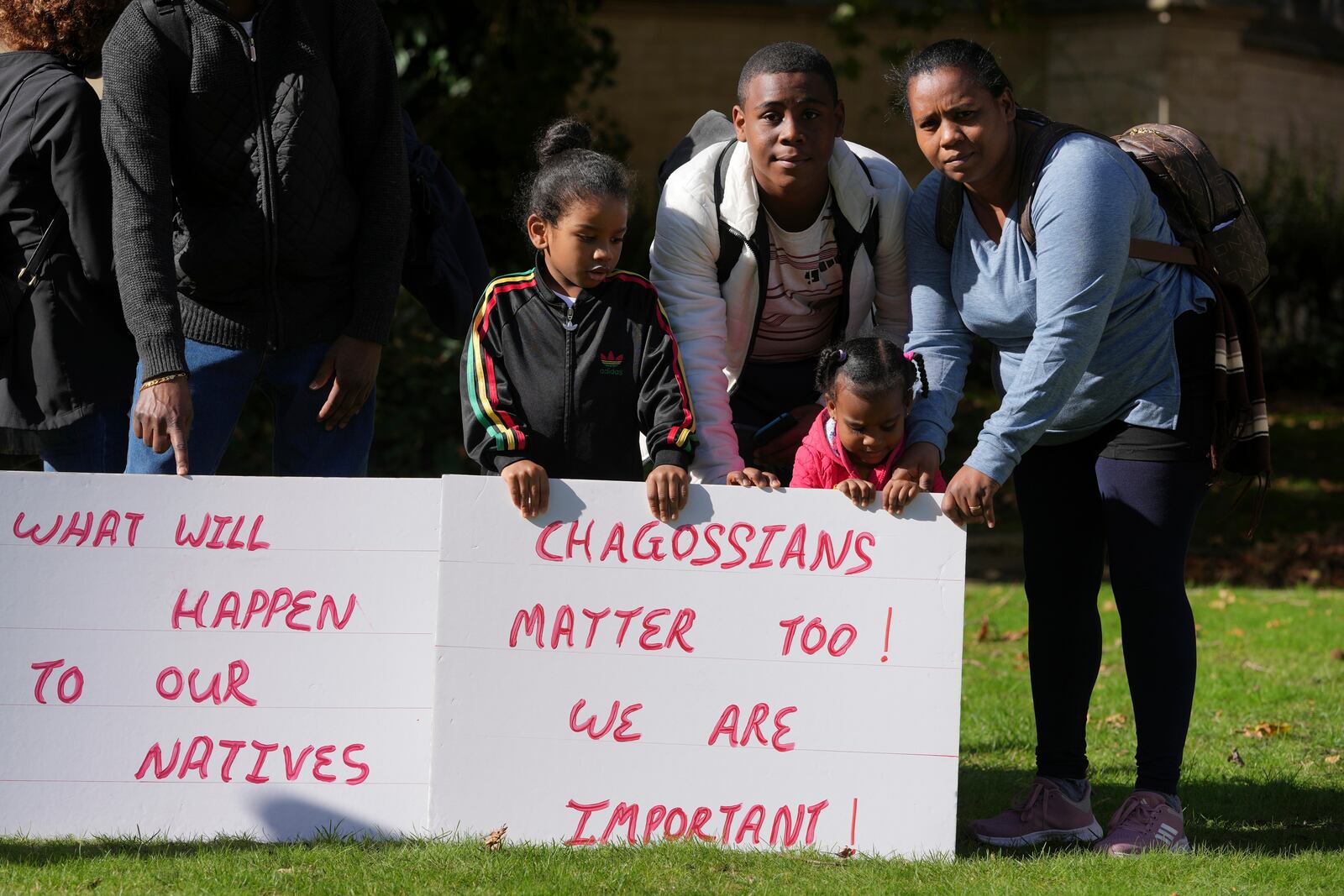 Chagossians Marie Michele, right, attends a protest to respond to the U.K. announcement agreeing to hand sovereignty of the long-contested Chagos Islands to Mauritius and against their "Exclusion" from Chagos negotiations, outside the House of Parliament, in London, Monday, Oct. 7, 2024. (AP Photo/Kin Cheung)