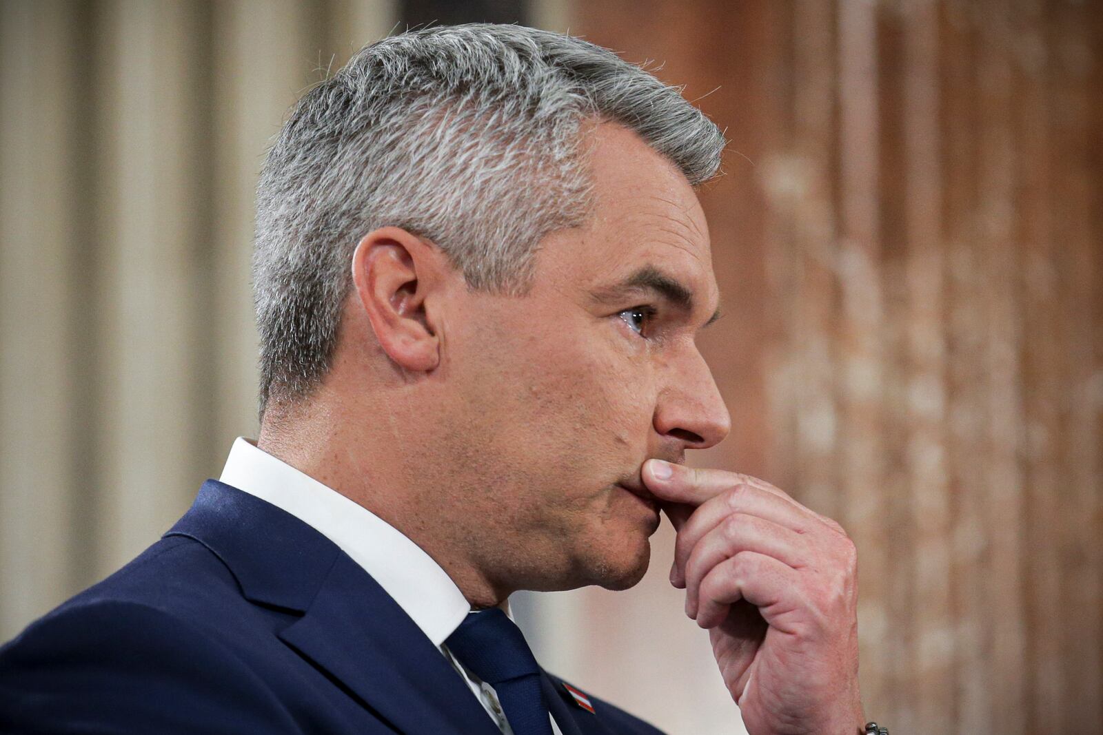 Austrian Chancellor Karl Nehammer gestures at the national broadcaster studio, set up in the parliament building, in Vienna, Austria, Sunday, Sept. 29, 2024, after polls closed in the country's national election. (AP Photo/Heinz-Peter Bader)