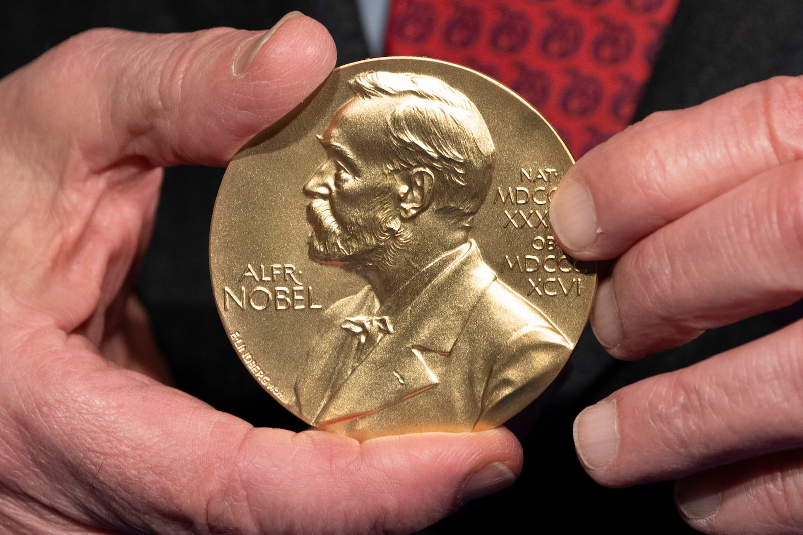 FILE - A close-up view of a Nobel Prize medal at the National Institutes of Health (NIH) in Bethesda, Md., Tuesday, Dec. 8, 2020. (AP Photo/Jacquelyn Martin, File)