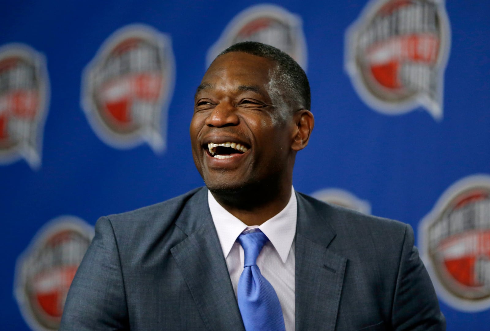 FILE - Former NBA basketball player Dikembe Mutombo laughs during a news conference announcing him as one of the 12 finalists of this year's hall of fame class during an event ahead of the NBA All Star basketball game, on Feb. 14, 2015, in New York. (AP Photo/Julio Cortez, File)