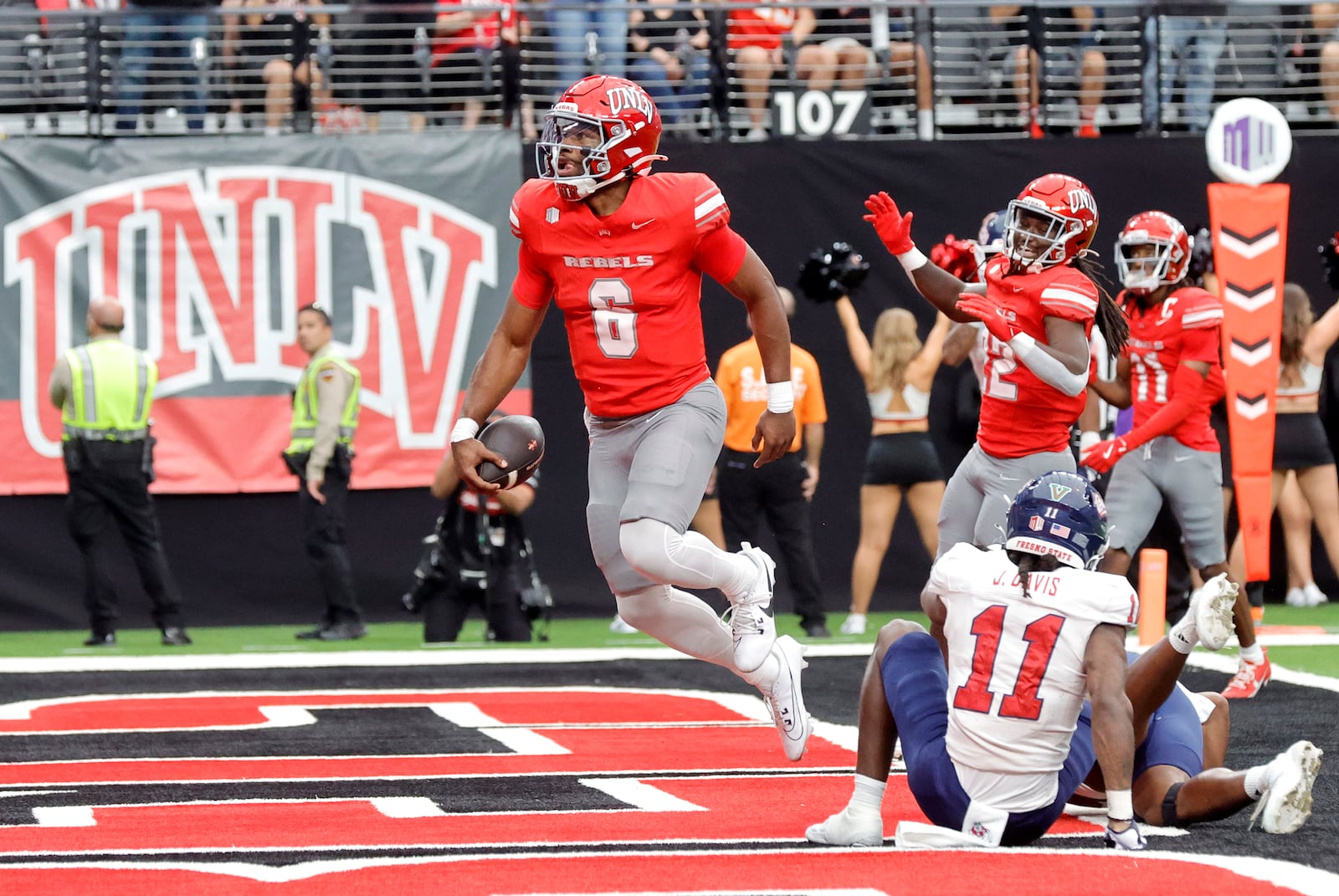 UNLV running back Jai'Den Thomas (9) celebrates after running for a touchdown past Fresno State defensive back Jayden Davis (11) during the first half of a NCAA football game, Saturday, Sept. 28, 2024, in Las Vegas. (Steve Marcus/Las Vegas Sun via AP)